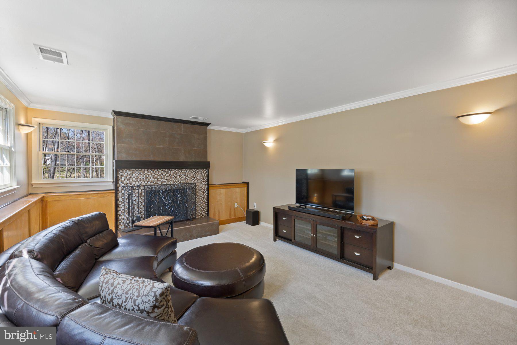 9008 Arley Drive Springfield, VA 22153 - Photo 26 of 40 a living room with fireplace furniture and a flat screen tv