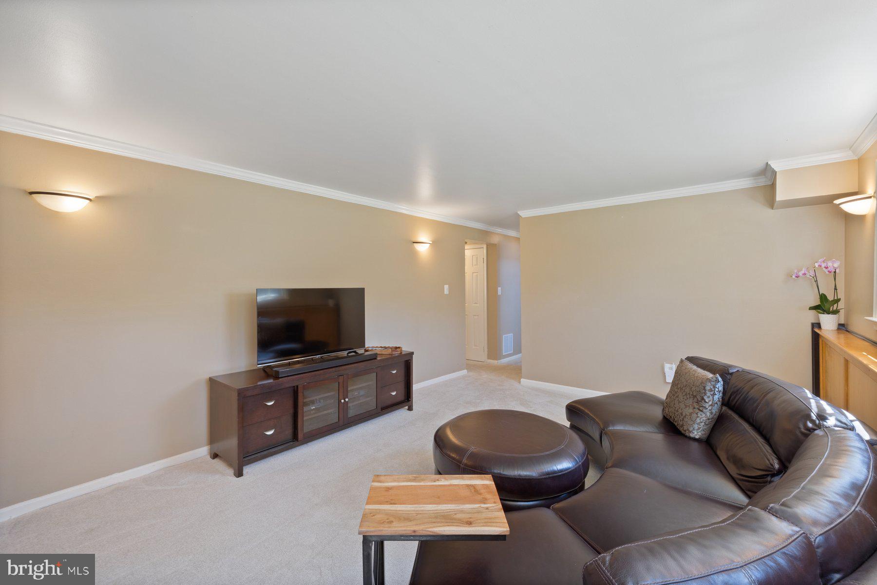 9008 Arley Drive Springfield, VA 22153 - Photo 27 of 40 a living room with furniture and a flat screen tv