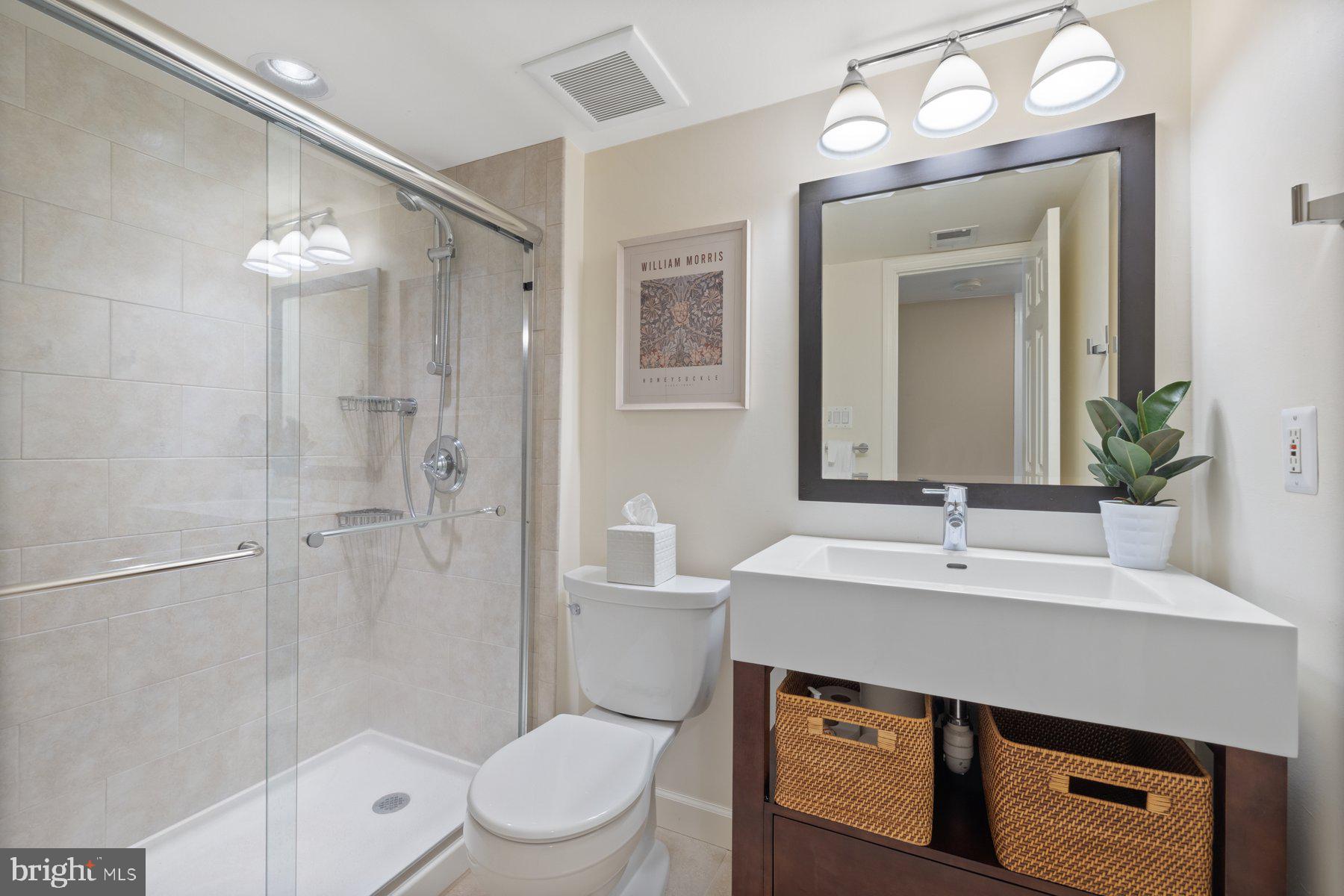 9008 Arley Drive Springfield, VA 22153 - Photo 30 of 40 a bathroom with a sink a toilet and shower