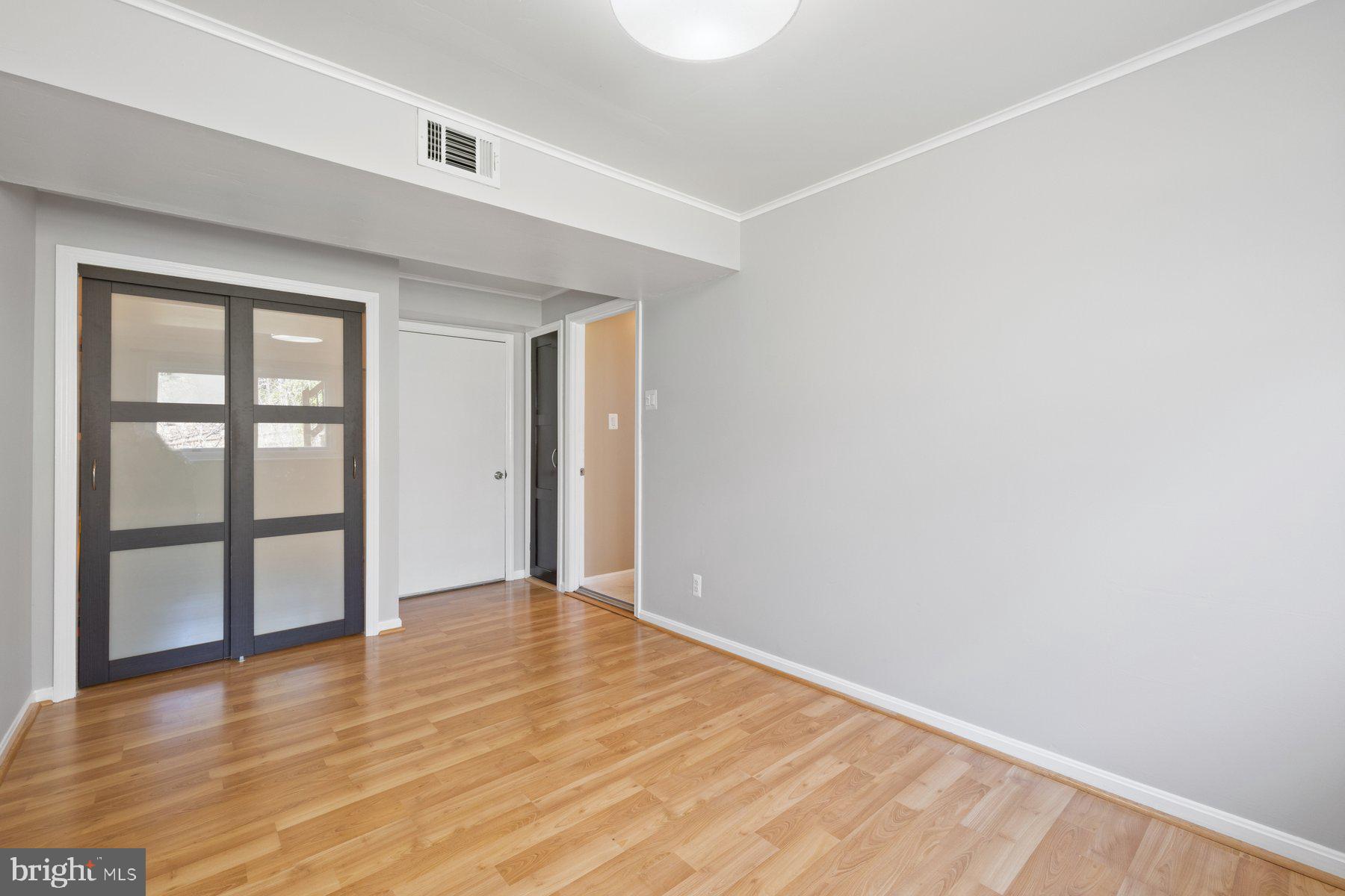 9008 Arley Drive Springfield, VA 22153 - Photo 33 of 40 a view of an empty room with wooden floor and window