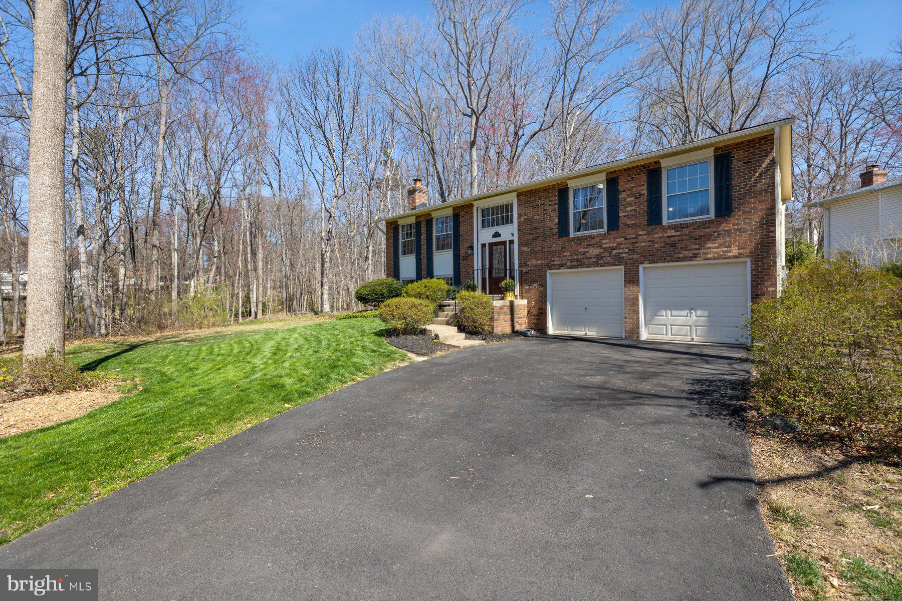 9008 Arley Drive Springfield, VA 22153 - Photo 37 of 40 a front view of a house with a yard and garage