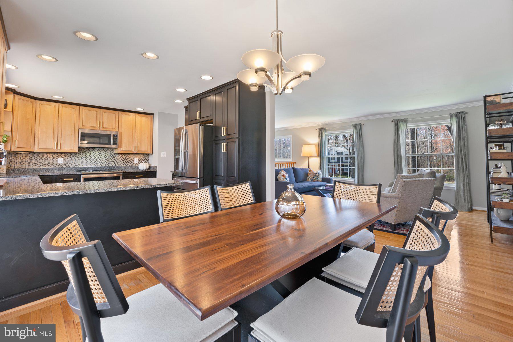 9008 Arley Drive Springfield, VA 22153 - Photo 5 of 40 a dining room filled chandelier and wooden floor