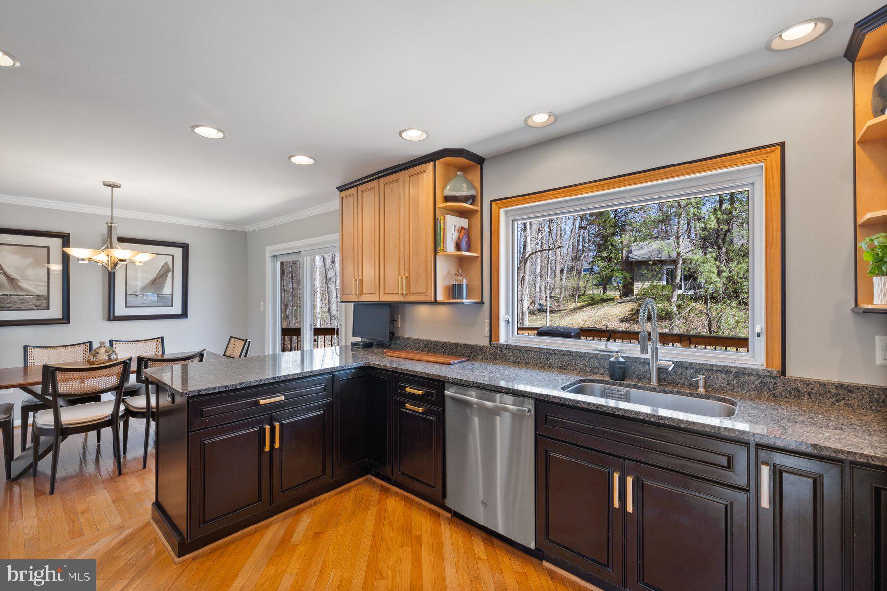 9008 Arley Drive Springfield, VA 22153 - Photo 7 of 40 a kitchen with a sink and wooden cabinets