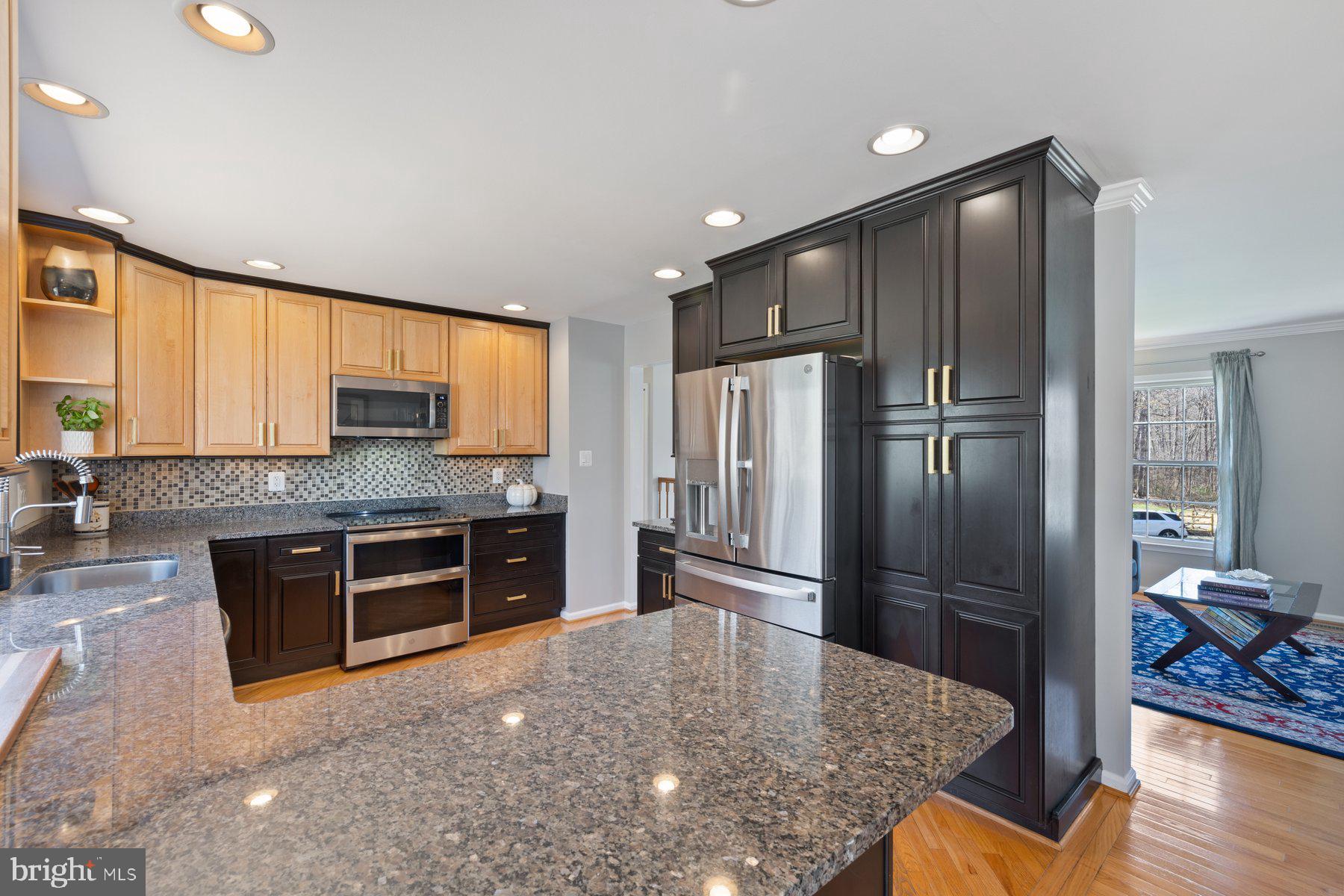 9008 Arley Drive Springfield, VA 22153 - Photo 8 of 40 a kitchen with stainless steel appliances granite countertop a refrigerator a stove and a sink