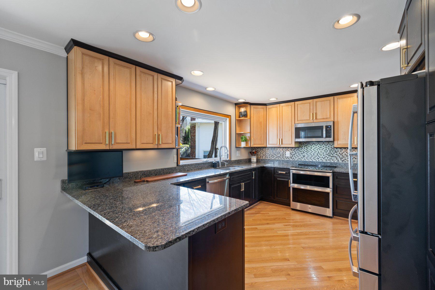 9008 Arley Drive Springfield, VA 22153 - Photo 9 of 40 a kitchen with stainless steel appliances granite countertop a sink and cabinets