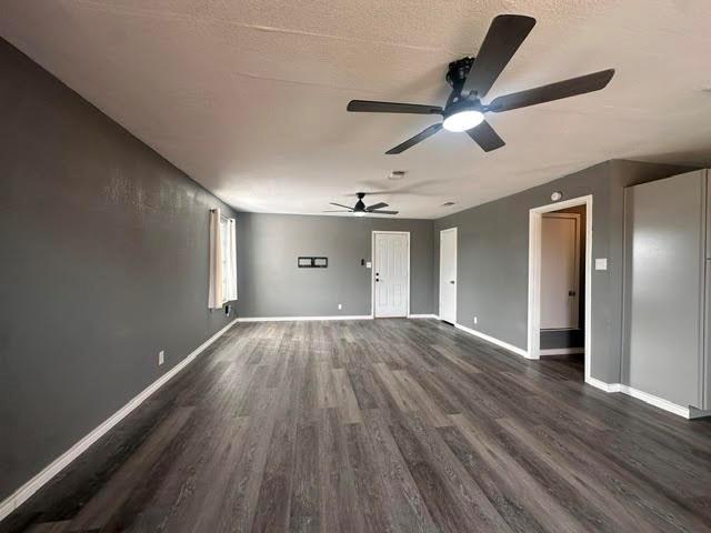 230 Bell Street Bangs, TX 76823 - Photo 1 of 7 a view of empty room with wooden floor and ceiling fan