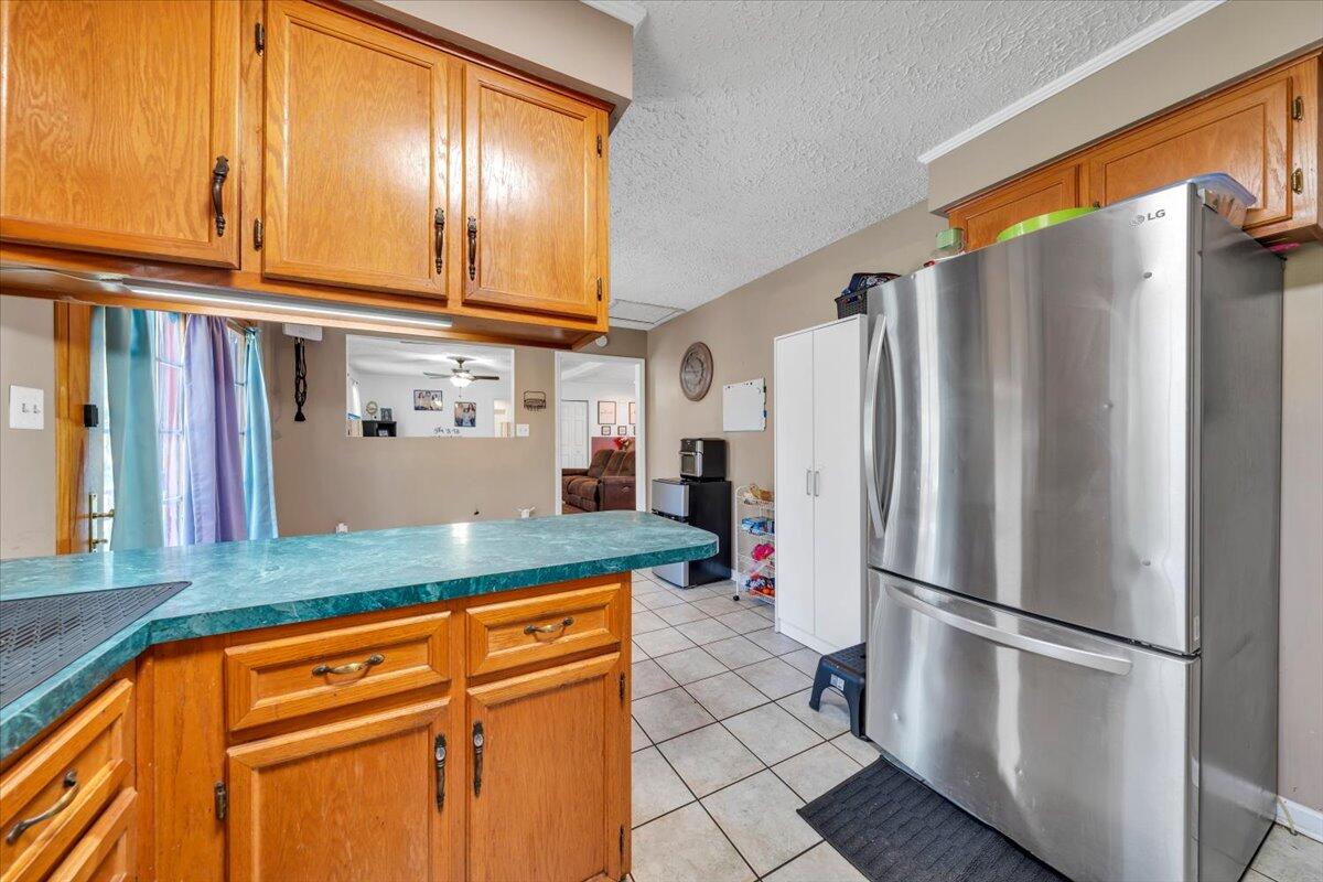 3870 Goose Dam Road Rocky Mount, VA 24151 - Photo 17 of 44 a kitchen with stainless steel appliances granite countertop a refrigerator a oven and white cabinets with wooden floors