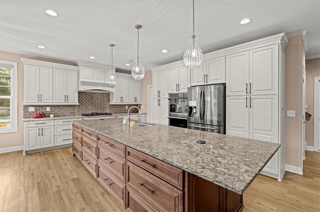 5320 North Helton Road Winston, GA 30187 - Photo 19 of 100 a kitchen with stainless steel appliances granite countertop a stove refrigerator and cabinets