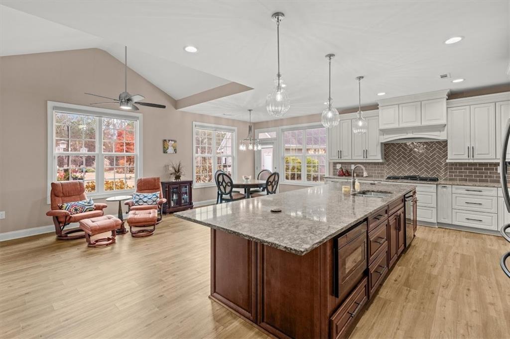 5320 North Helton Road Winston, GA 30187 - Photo 22 of 100 a kitchen with stainless steel appliances granite countertop a kitchen island a stove and a wooden floors