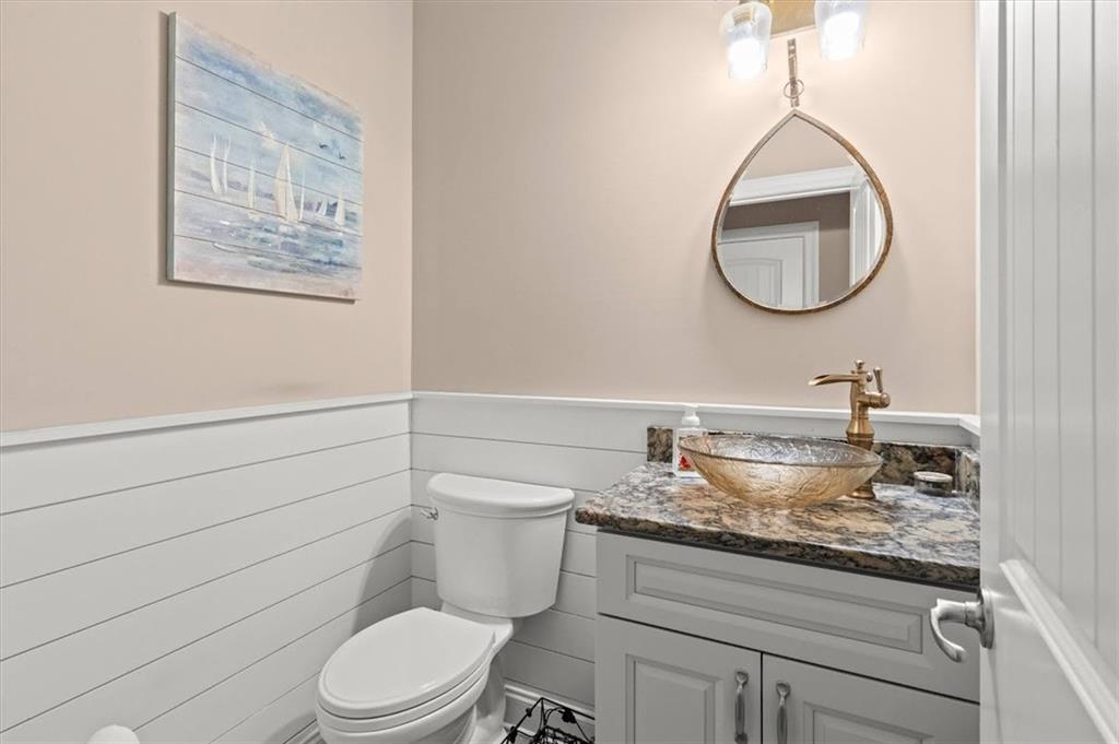 5320 North Helton Road Winston, GA 30187 - Photo 35 of 100 a bathroom with a granite countertop toilet sink mirror and vanity
