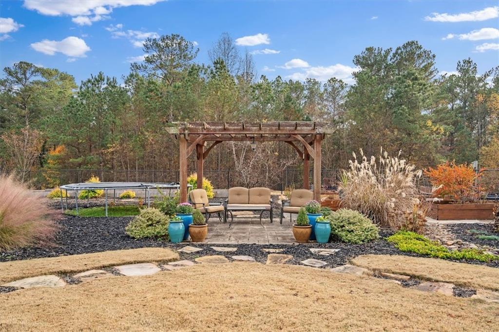 5320 North Helton Road Winston, GA 30187 - Photo 51 of 100 a view of a patio with a table and chairs under an umbrella