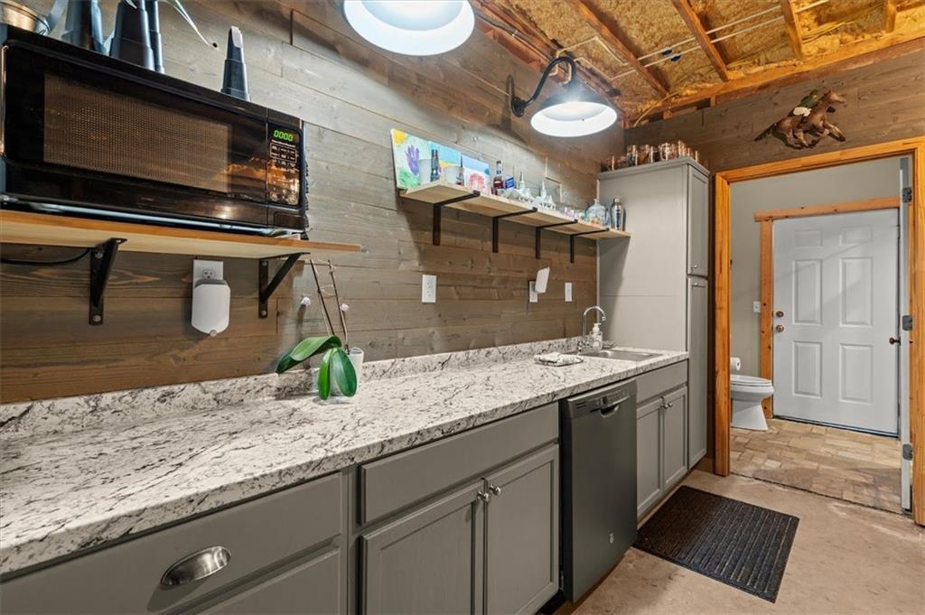 5320 North Helton Road Winston, GA 30187 - Photo 63 of 100 a kitchen with stainless steel appliances granite countertop a sink a stove and a microwave oven