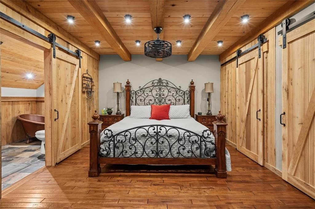 5320 North Helton Road Winston, GA 30187 - Photo 71 of 100 a bedroom with a large bed and a chandelier