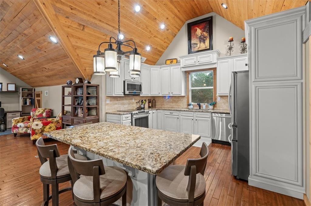 5320 North Helton Road Winston, GA 30187 - Photo 72 of 100 a kitchen with a table chairs refrigerator and cabinets