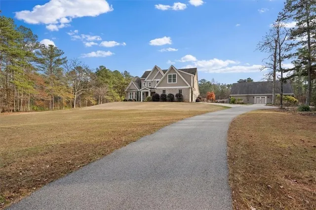 a living room with furniture and a dining table with kitchen view