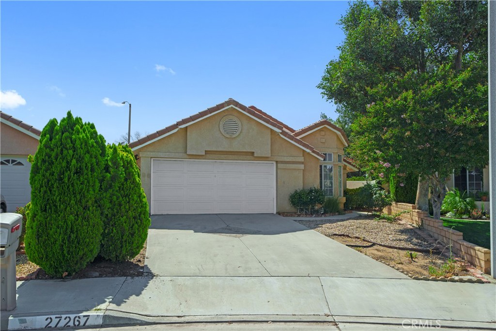 27267 Prominence Road Menifee, CA 92586 - Photo 1 of 1 a front view of a house with a yard and trees