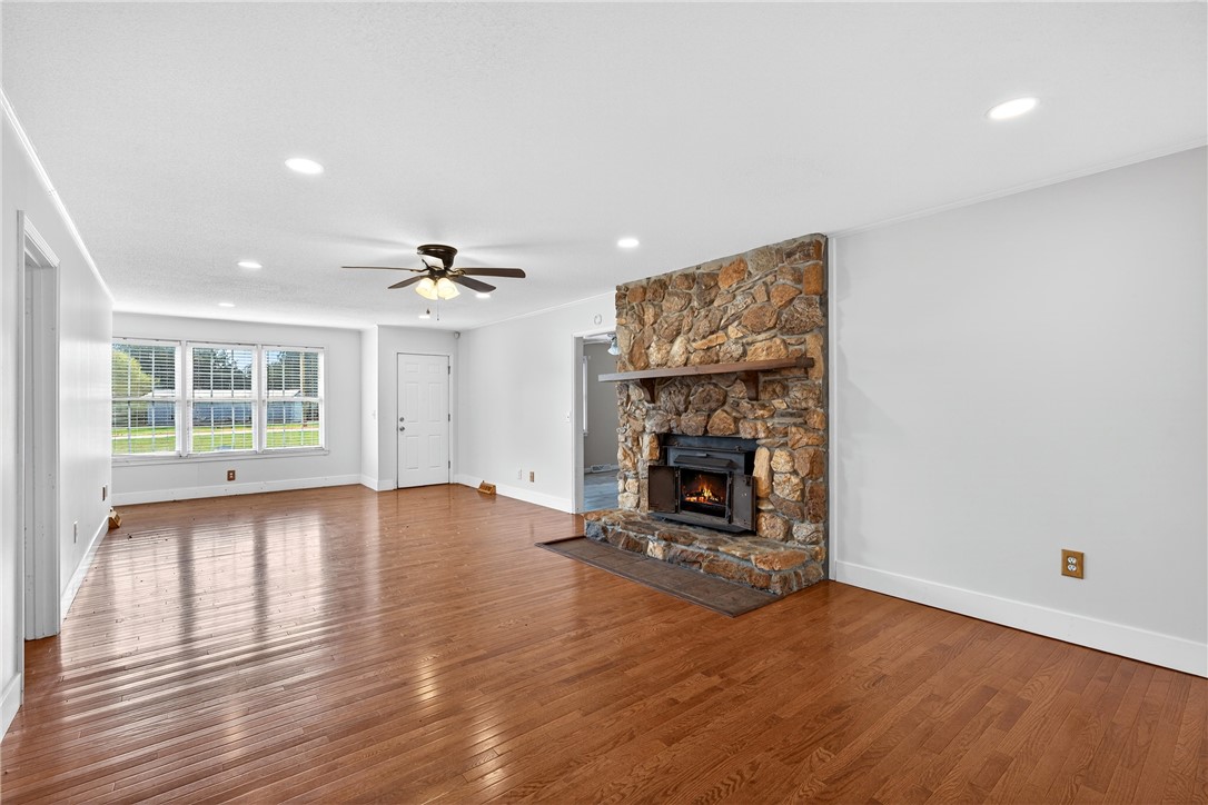 160 Burdette Circle Pendleton, SC 29670 - Photo 12 of 38 This expansive living space features a captivating stone fireplace, warm hardwood floors, and abundant natural light.