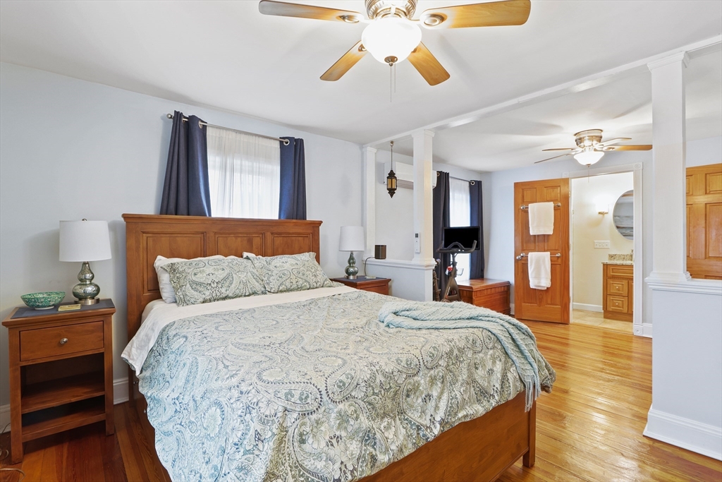 42 Partridge Street Boston, MA 02132 - Photo 14 of 33 a bedroom with a bed and wooden floor