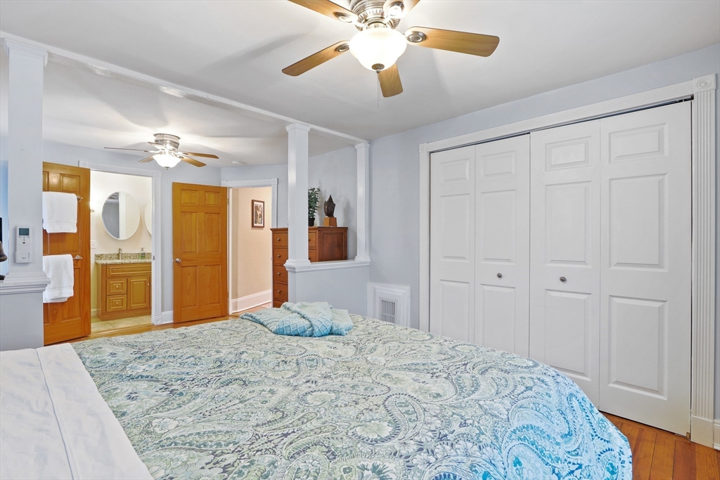 42 Partridge Street Boston, MA 02132 - Photo 15 of 33 a bedroom with a large bed and a chandelier