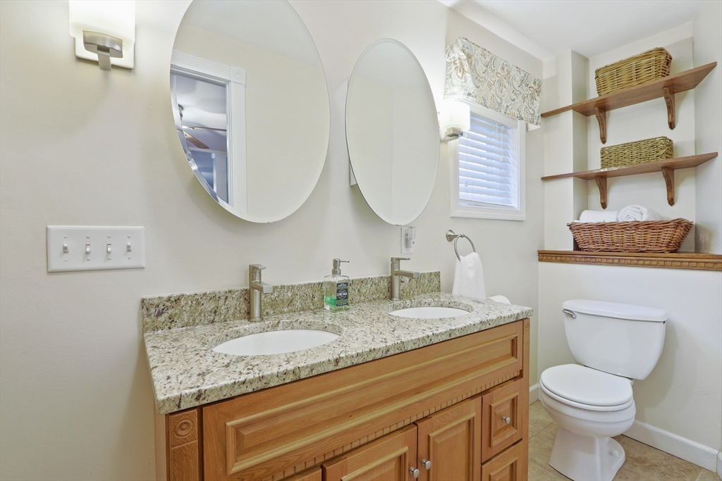 42 Partridge Street Boston, MA 02132 - Photo 17 of 33 a bathroom with a granite countertop toilet sink and mirror
