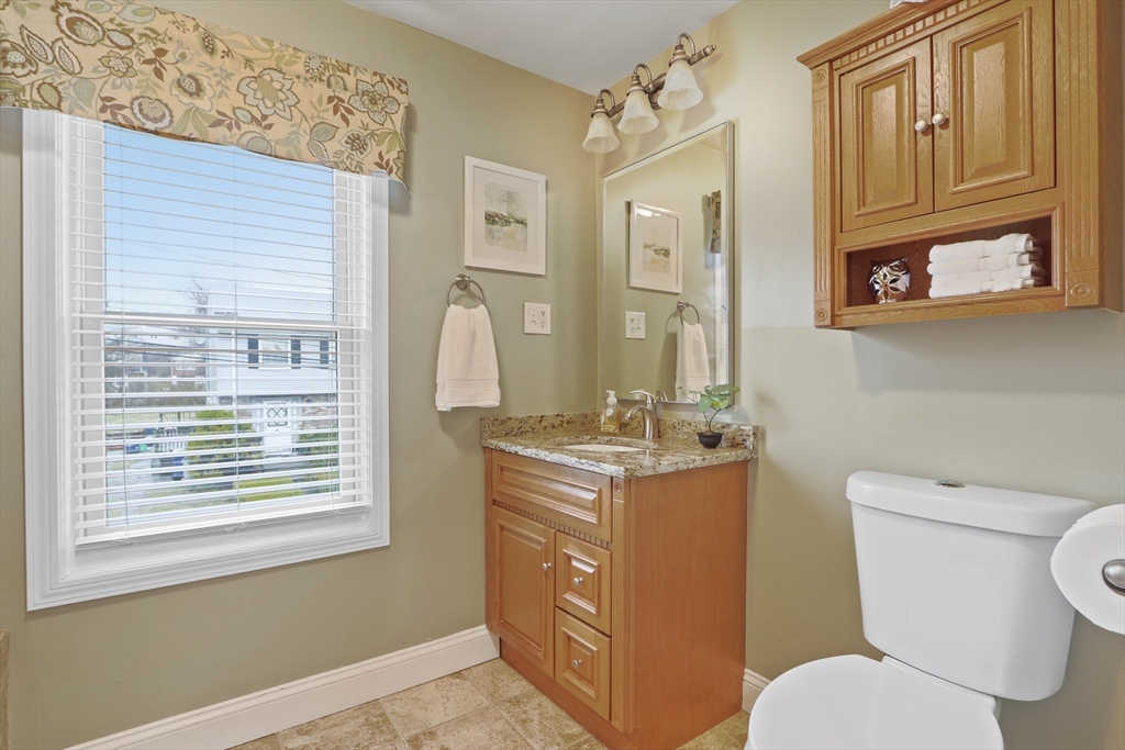 42 Partridge Street Boston, MA 02132 - Photo 20 of 33 a bathroom with a granite countertop toilet sink and mirror