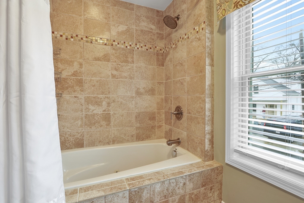 42 Partridge Street Boston, MA 02132 - Photo 21 of 33 a bath tub sitting next to a window