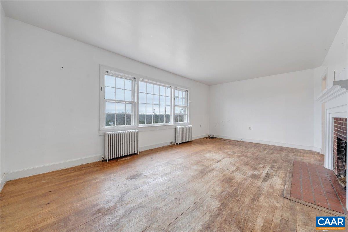 2420 James River Road Esmont, VA 22937 - Photo 13 of 75 an empty room with wooden floor and windows