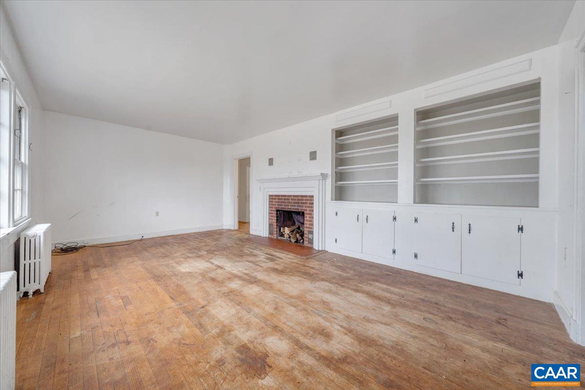 2420 James River Road Esmont, VA 22937 - Photo 14 of 75 a view of an empty room with a fireplace and a window