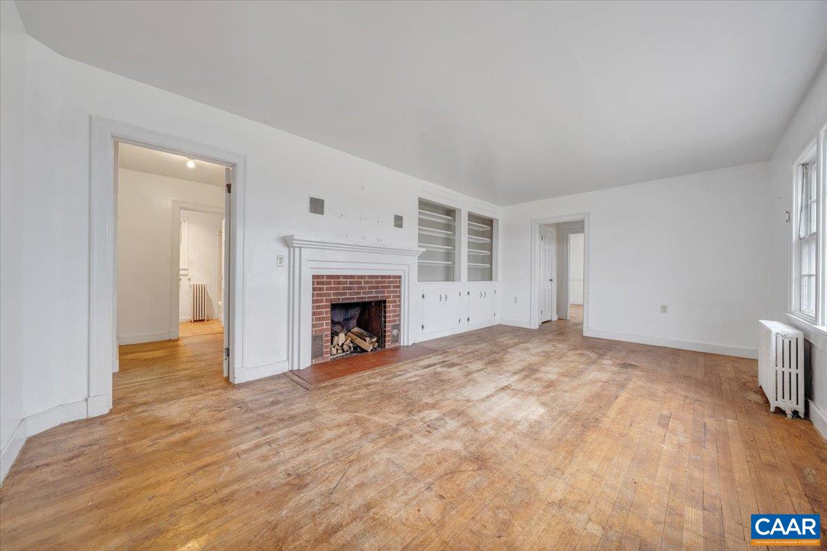 2420 James River Road Esmont, VA 22937 - Photo 15 of 75 a view of empty room with wooden floor and fireplace