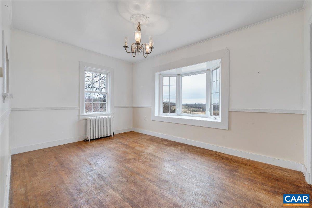 2420 James River Road Esmont, VA 22937 - Photo 16 of 75 a view of an empty room with a window and wooden floor