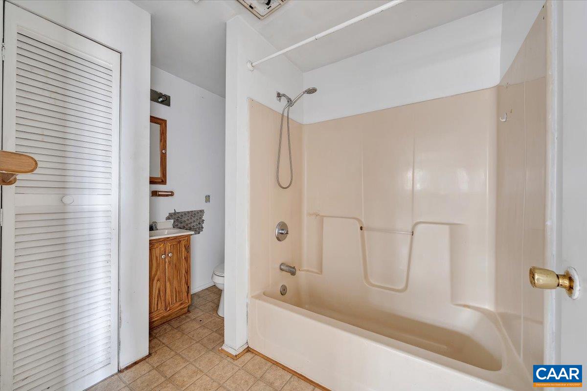 2420 James River Road Esmont, VA 22937 - Photo 60 of 75 a bathroom with a tub shower vanity and a sink