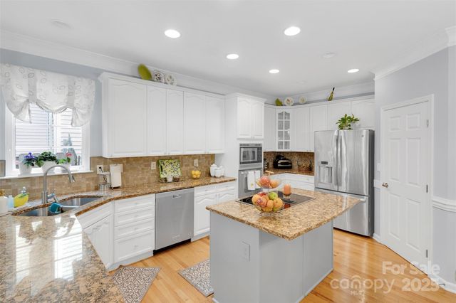 a kitchen with a dining table chairs stove and kitchen view