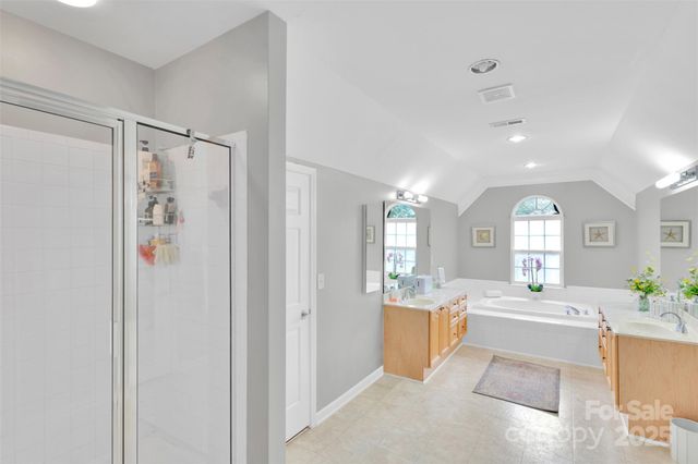 a view of walk in closet with clothes