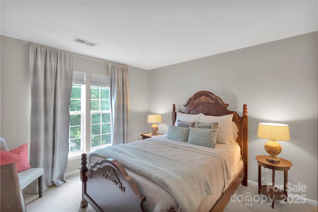 a bedroom with a bed and a night stand