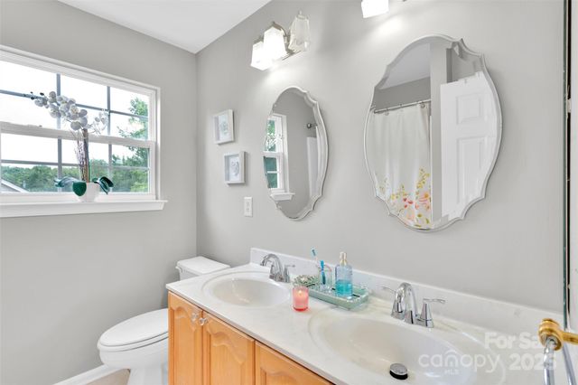 a bedroom with a bed and a lamp next to a window