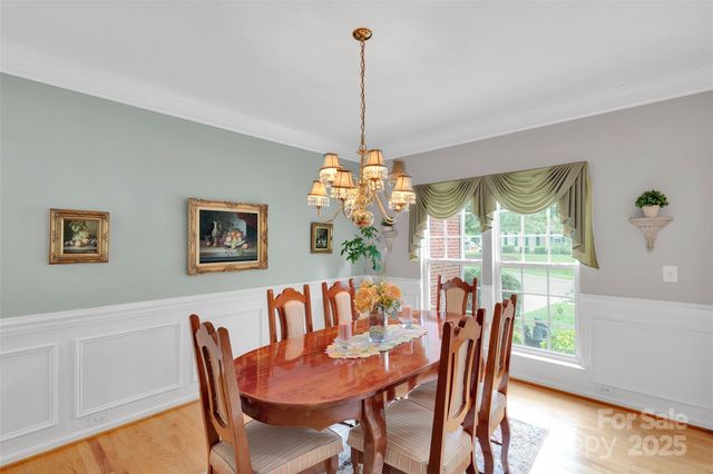 a dining room with furniture a chandelier and window