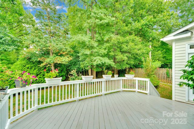a view of an house with backyard space and balcony