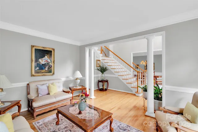 a living room with furniture and a painting on the wall