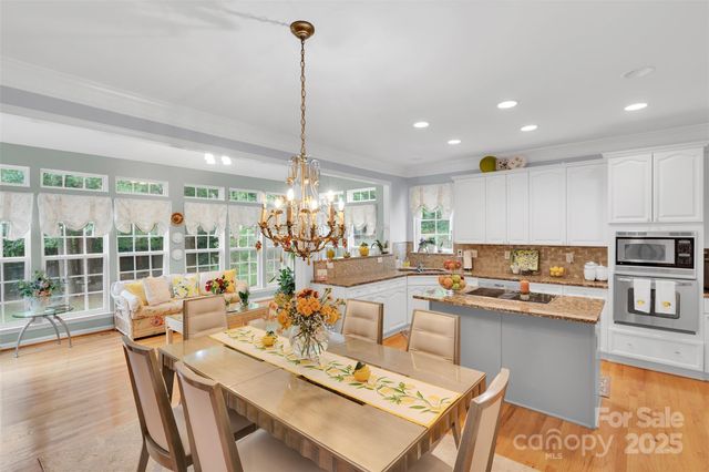 a large kitchen with a counter top space and living room