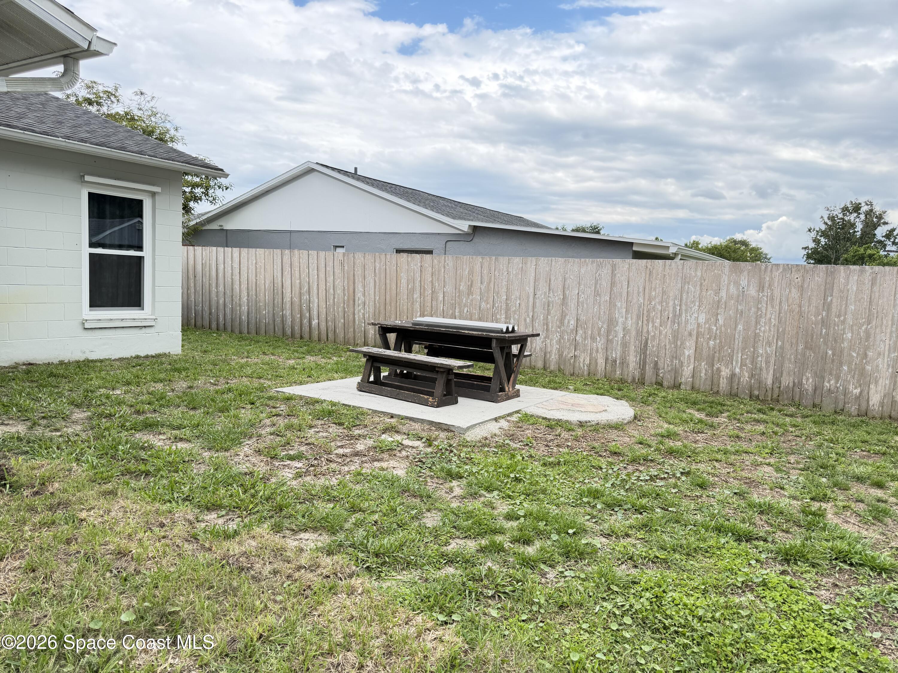 1578 West Powder Horn Road Titusville, FL 32796 - Photo 22 of 22 a backyard of a house with table and chairs