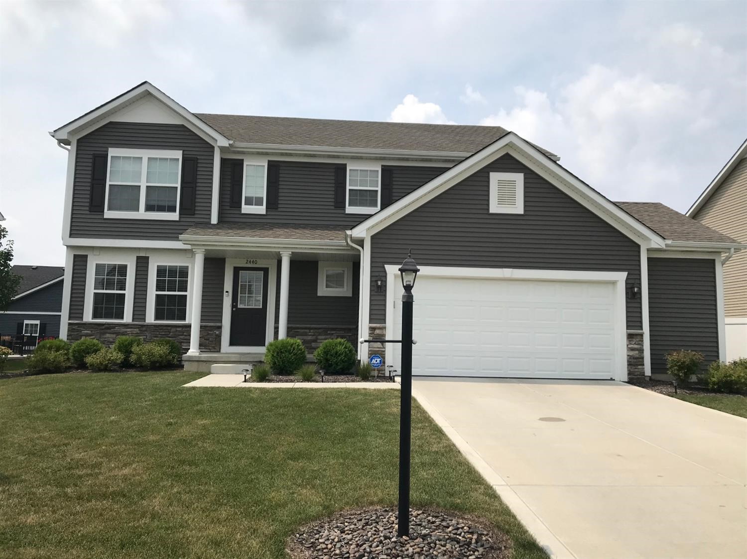 a front view of a house with a yard and garage