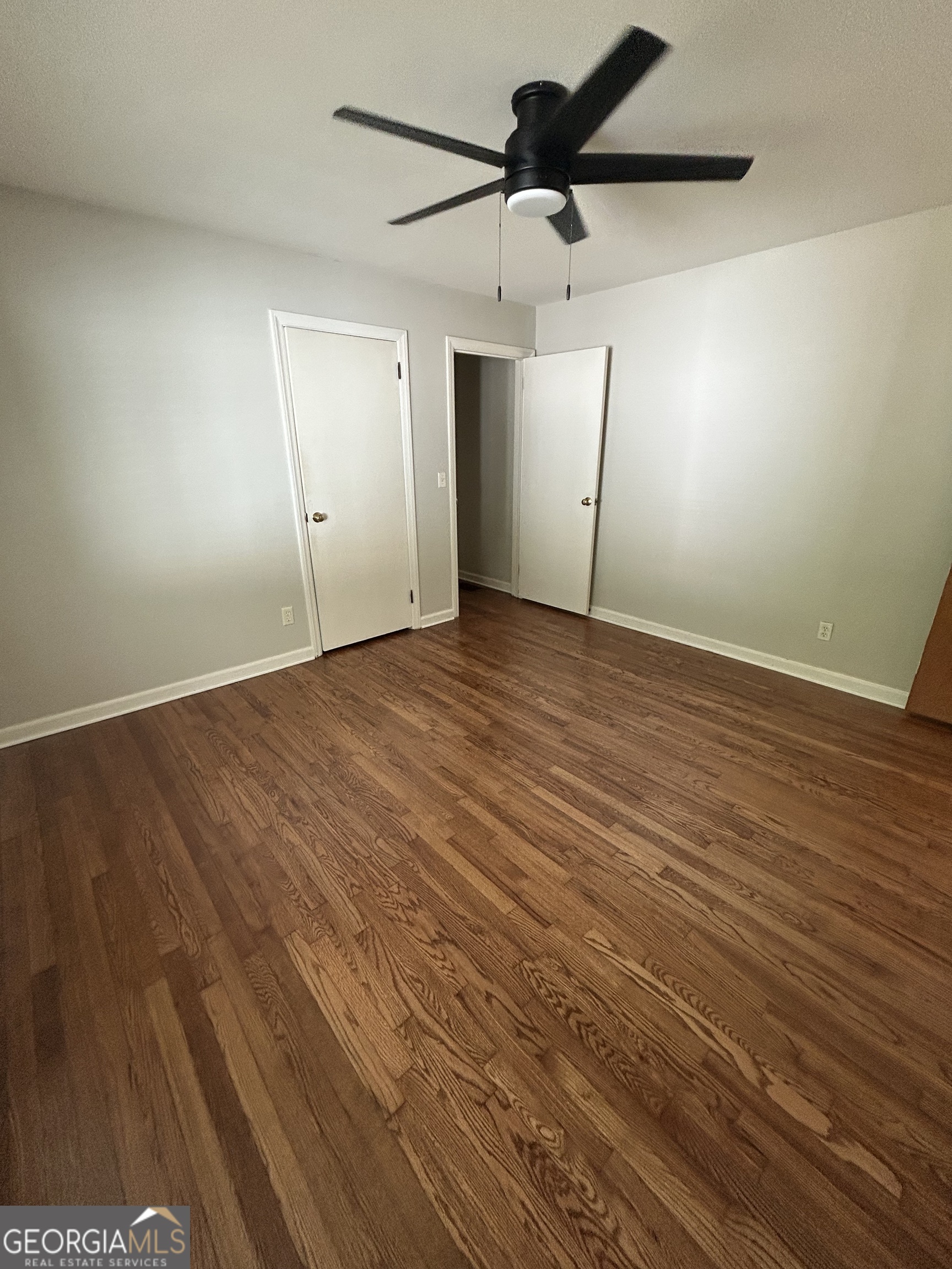 2 Ford Road Southeast Rome, GA 30161 - Photo 11 of 19 an empty room with wooden floor a ceiling fan and windows