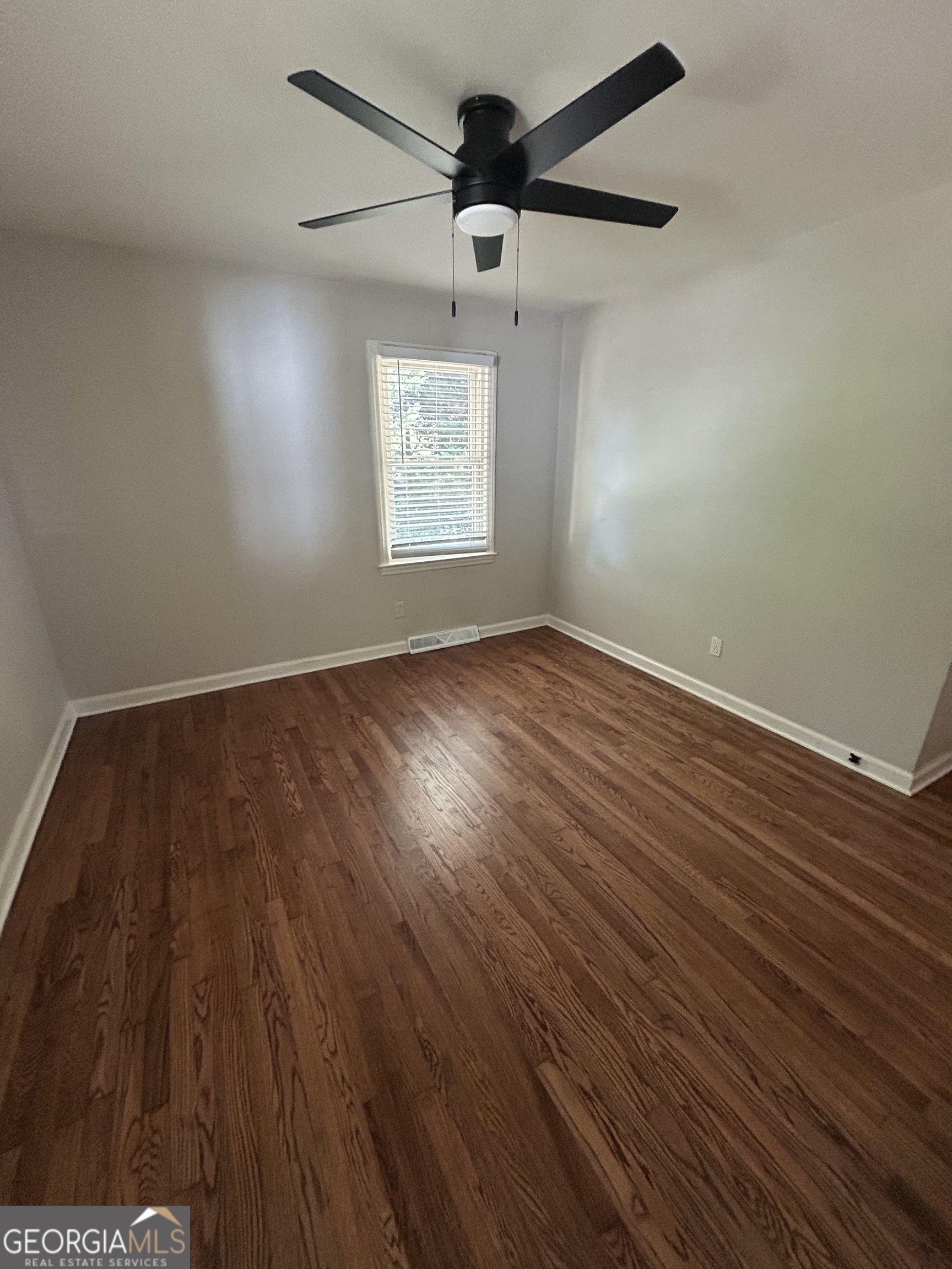 2 Ford Road Southeast Rome, GA 30161 - Photo 13 of 19 an empty room with wooden floor chandelier fan and windows