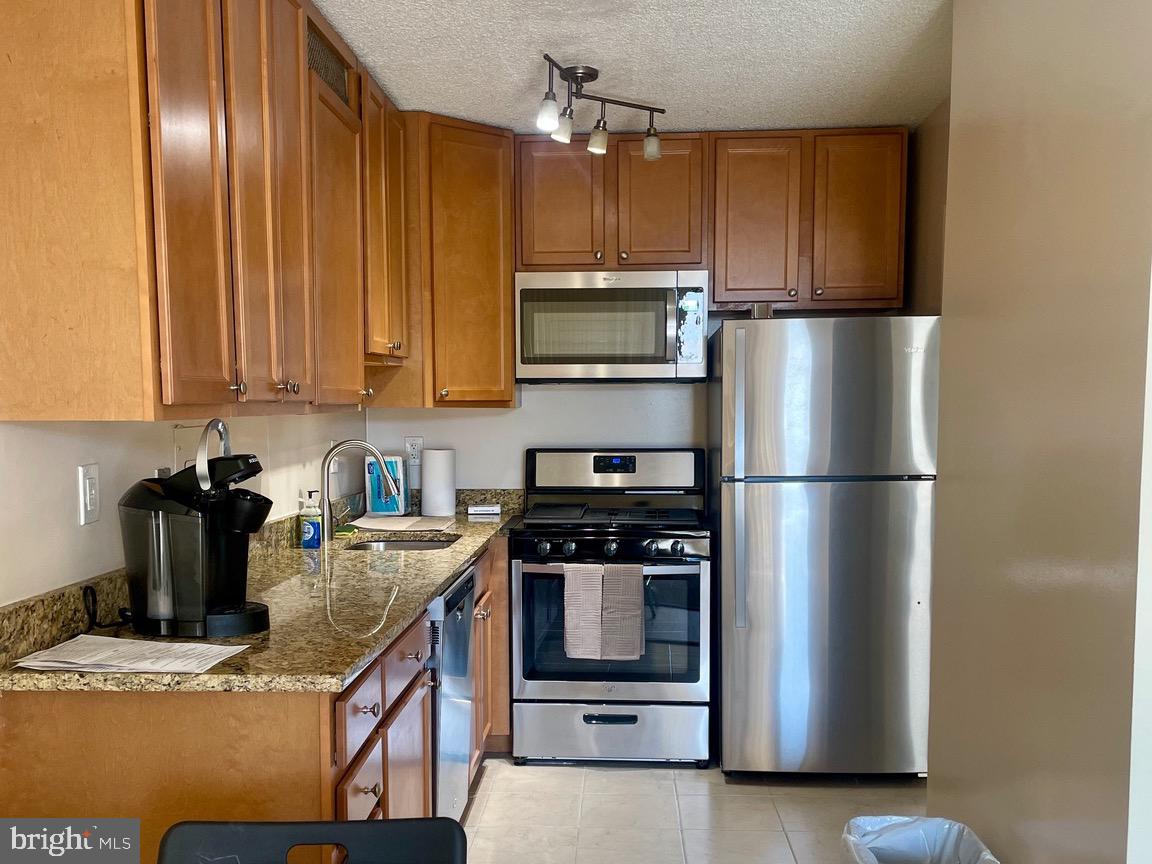 5225 Pooks Hill Road, Unit 1607N Bethesda, MD 20814 - Photo 1 of 51 a kitchen with stainless steel appliances granite countertop a refrigerator a stove a sink and dishwasher