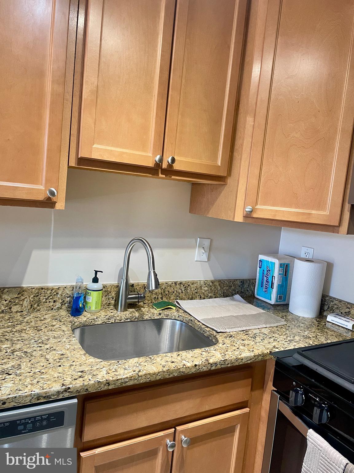 5225 Pooks Hill Road, Unit 1607N Bethesda, MD 20814 - Photo 4 of 51 a kitchen with granite countertop stainless steel appliances a sink stove and cabinets