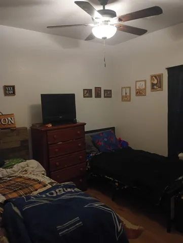 a bedroom with a bed and a television