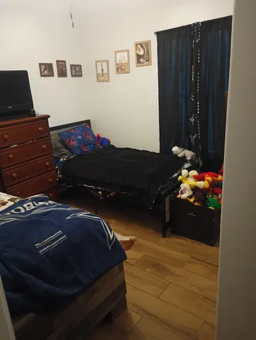 a bedroom with a bed and dresser