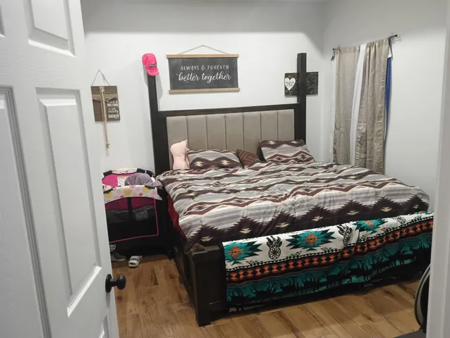 a bed sitting in a bedroom next to a window