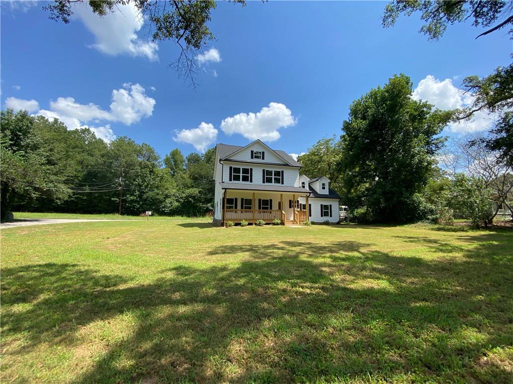a large pool with lawn chairs under an umbrella