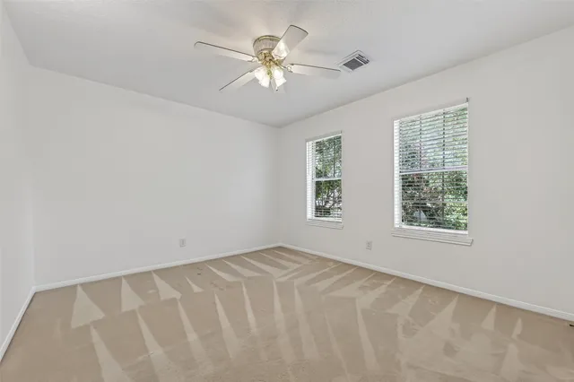 a view of a house with a yard and large tree